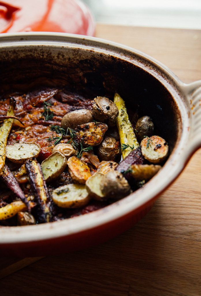 Roasted root vegetables in a rustic ceramic dish