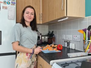 Sahara in her kitchen chopping vegetables